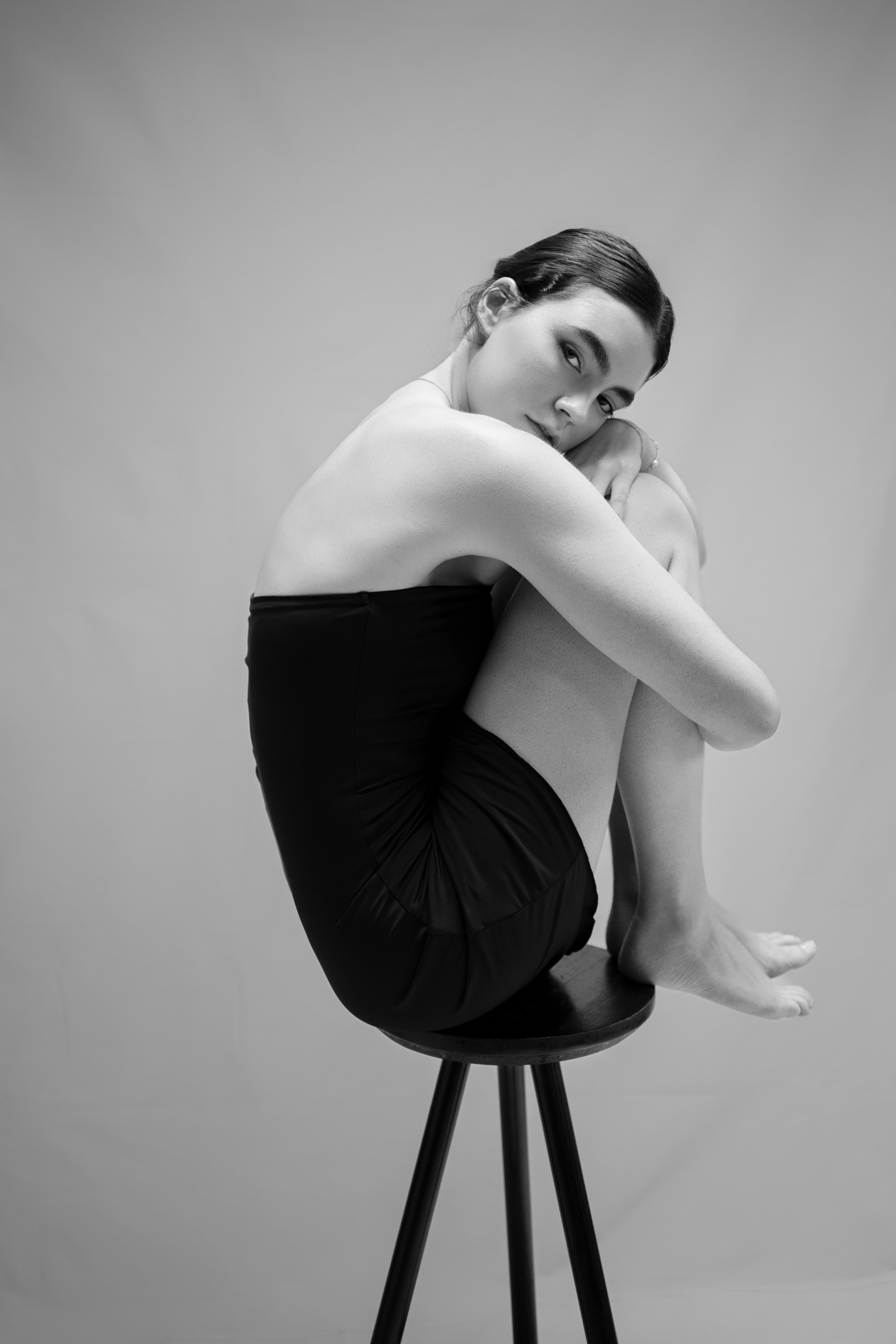 Sculptural black and white seated portrait